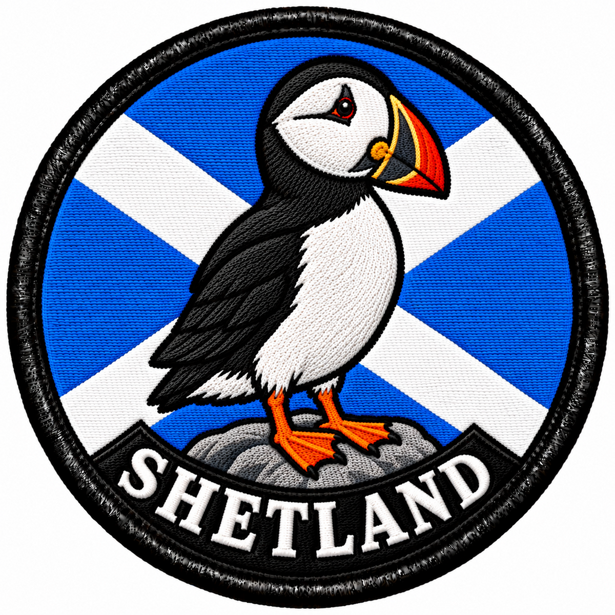 Round 80mm embroidered patch showing a puffin standing on a rock against a Saltire, with SHETLAND lettering along the bottom, framed by a black border.
