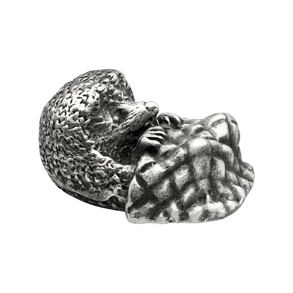 Opposite view of English-made pewter hedgehog with blanket figurine showing hedgehog face and textured spines