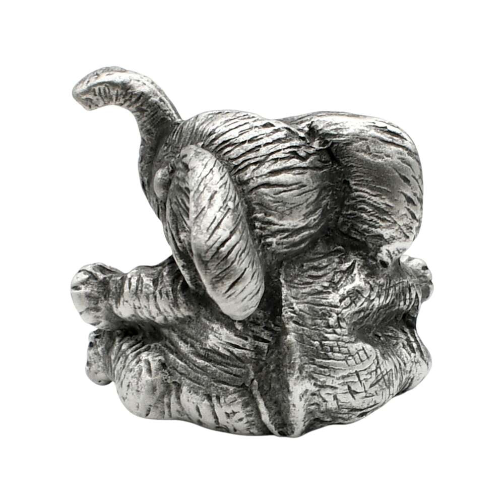 Rear view of English-made pewter baby elephant ornament showing large ears, curved trunk and textured back