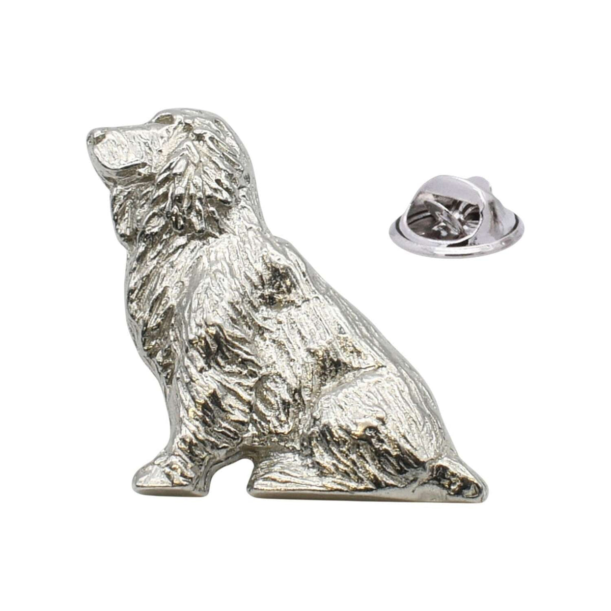Shiny bright silver-coloured seated spaniel dog lapel pin with detailed fur and butterfly fastening