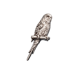 Handcrafted pewter budgerigar pin badge featuring a budgie perched on a branch.