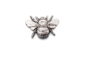 Detailed pewter Bee pin badge with textured body and sculpted wings on a white background.