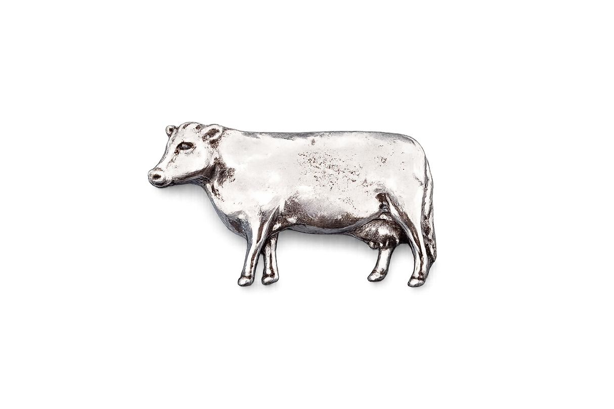 Detailed pewter dairy cow pin badge with butterfly clutch fastening on a white background.