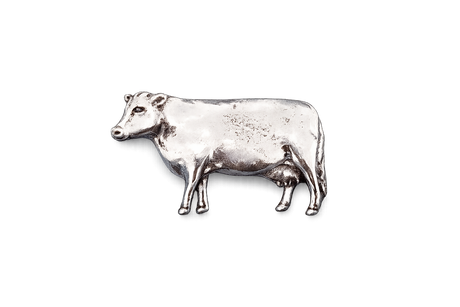 Detailed pewter dairy cow pin badge with butterfly clutch fastening on a white background.