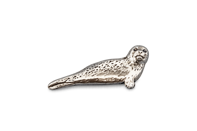 Detailed pewter seal pin badge with butterfly clutch fastening on a white background.