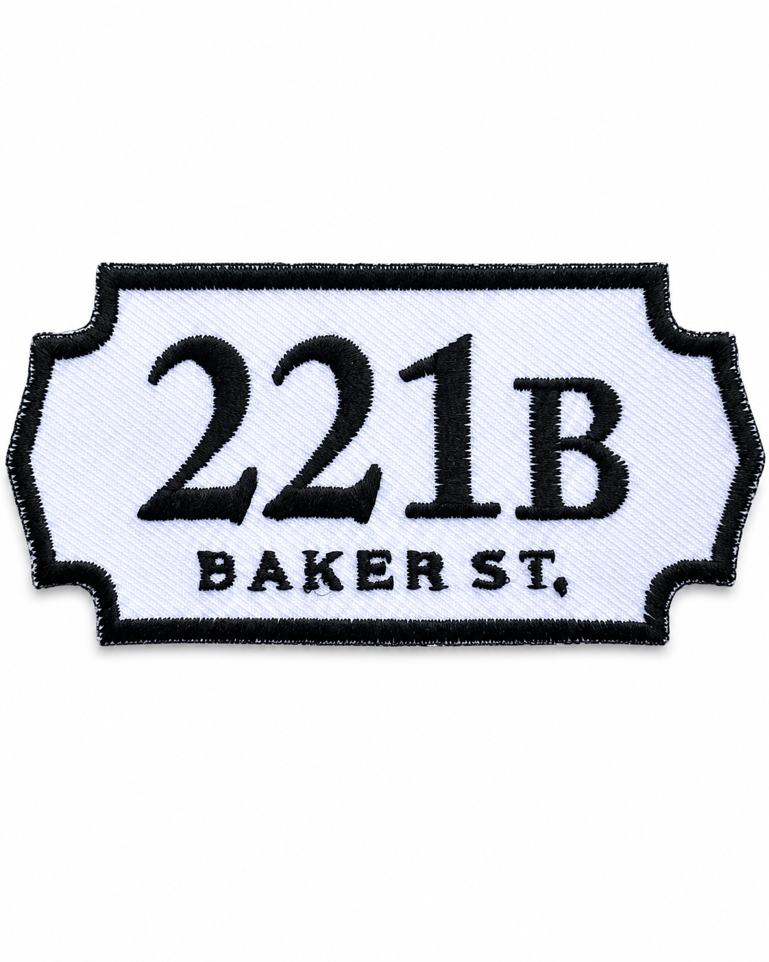 221B Baker Street embroidered patch inspired by the famous Sherlock Holmes address, featuring black lettering on a white sign-shaped badge with a black stitched border, suitable for iron-on or sew-on application.