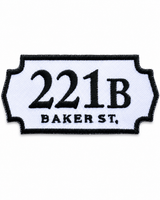221B Baker Street embroidered patch inspired by the famous Sherlock Holmes address, featuring black lettering on a white sign-shaped badge with a black stitched border, suitable for iron-on or sew-on application.