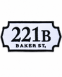221B Baker Street embroidered patch inspired by the famous Sherlock Holmes address, featuring black lettering on a white sign-shaped badge with a black stitched border, suitable for iron-on or sew-on application.