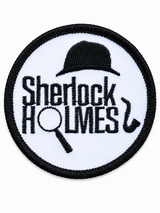 Round Sherlock Holmes embroidered patch featuring a bowler hat, magnifying glass and pipe in black on a white background with a black stitched border, suitable for iron-on or sew-on application.