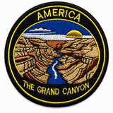 Round embroidered patch featuring the Grand Canyon in America with a canyon landscape, river and sunset, black and gold stitched border, suitable for iron-on or sew-on application.