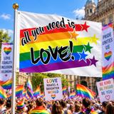 All You Need Is Love Pride Flag 5ft x 3ft displayed on a flagpole at a Pride rally