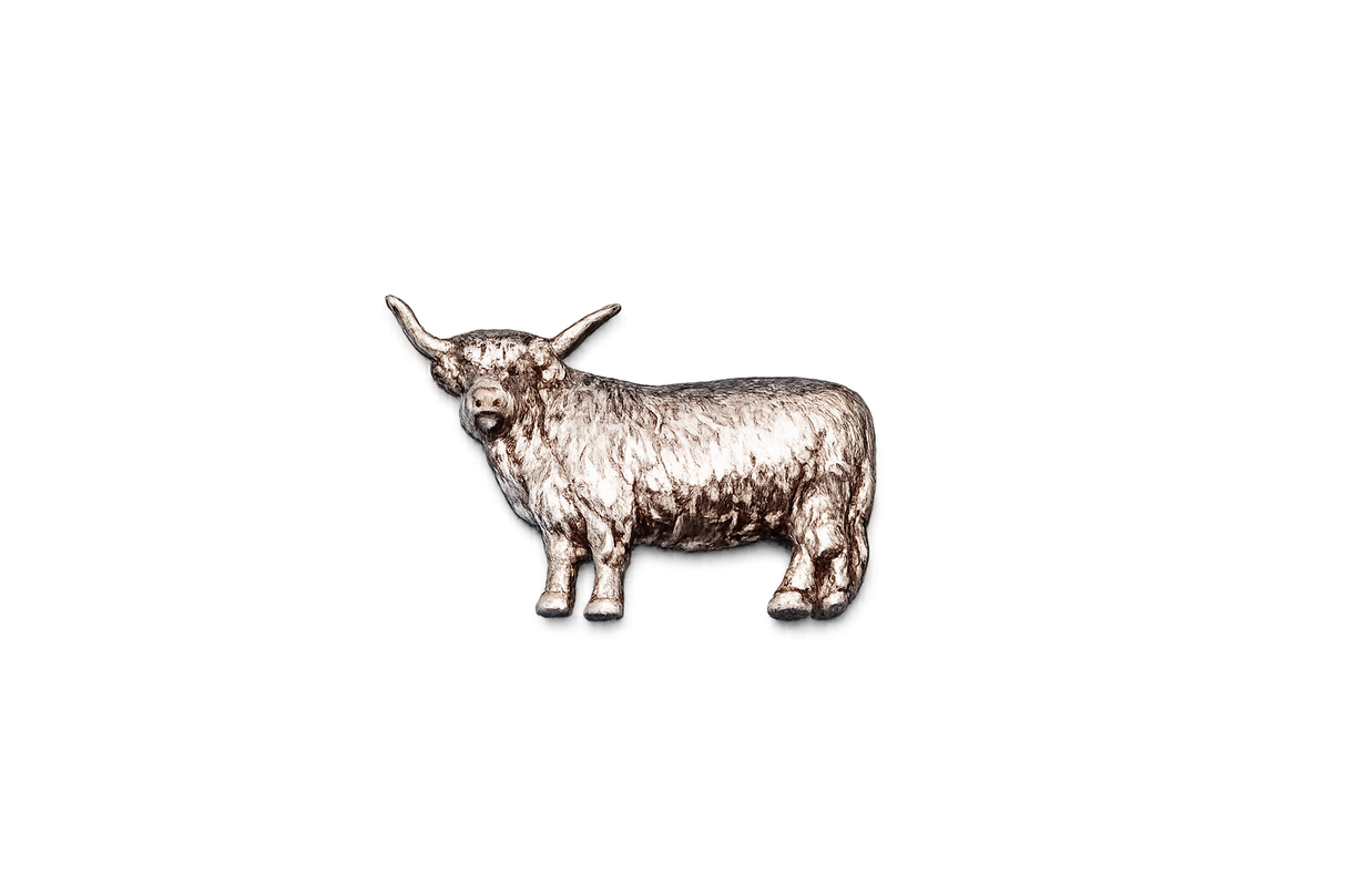 Handcrafted pewter Highland Cow pin badge featuring a detailed Scottish cattle design with butterfly clutch fastening on a white background.