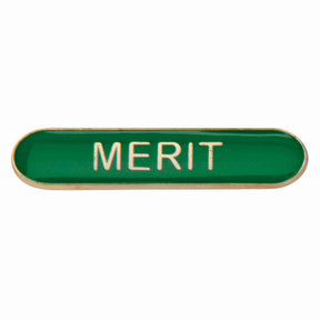 Merit school bar badge in green enamel with gold lettering and butterfly clutch fastening.