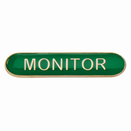 Monitor school bar badge in green enamel with gold lettering and butterfly clutch fastening.