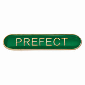 Prefect school bar badge in green enamel with gold lettering and butterfly clutch fastening.