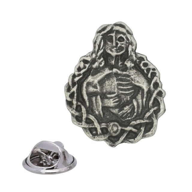 Antique silver Hel Norse mythology pewter lapel pin depicting half-living half-skeletal woman with decorative border and rear clasp