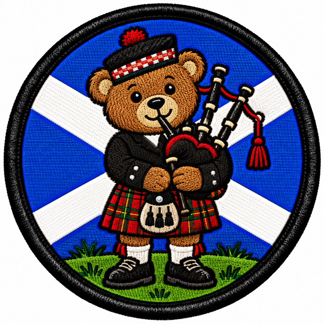 Round 80mm embroidered patch showing a teddy bear playing bagpipes in a red tartan kilt against a blue and white Saltire, framed by a black border.