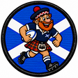 Round 80mm embroidered patch showing a smiling red-bearded rugby player in a tartan kilt carrying a rugby ball against a Saltire, framed by a black border.