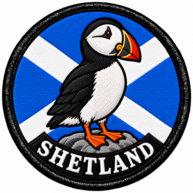 Round 80mm embroidered patch showing a puffin standing on a rock against a Saltire, with SHETLAND lettering along the bottom, framed by a black border.