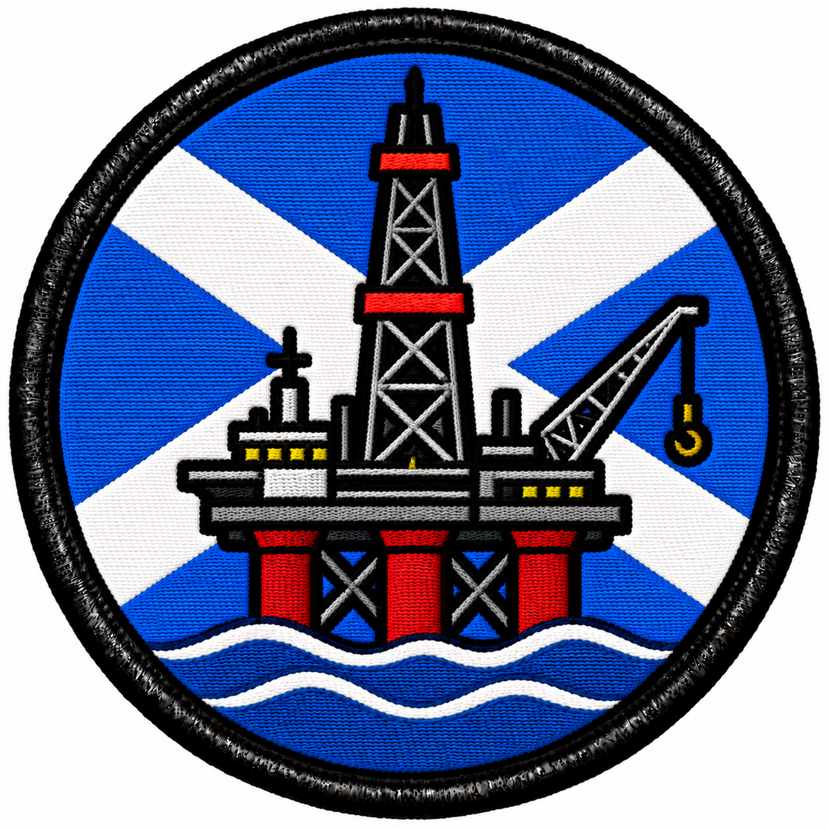 Round 80mm embroidered patch showing an offshore oil platform with a derrick and crane above waves, against a blue and white Saltire, framed by a black border.
