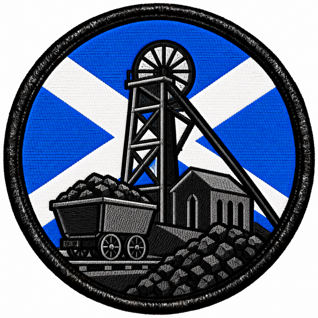 Round 80mm embroidered patch showing a coal mine pithead and winding wheel beside a coal wagon and heaps of coal, against a Saltire, framed by a black border.