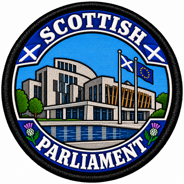 Round 80mm embroidered patch showing a stylised Scottish Parliament building with Scottish and European flags, thistles and SCOTTISH PARLIAMENT lettering, framed by a black border.