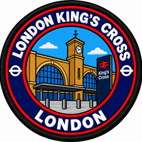 Round 80mm embroidered patch showing a stylised King's Cross station facade with twin arches, a clock tower and a railway sign, finished with a black border.