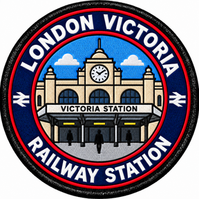 Round 80mm embroidered patch showing the Victoria station entrance and clock, with people outside and LONDON VICTORIA RAILWAY STATION lettering, finished with a black border.