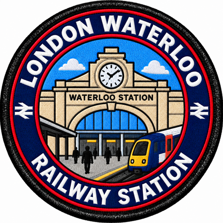 Round 80mm embroidered patch showing a stylised Waterloo station facade and clock with a passenger train and people outside, finished with a black border.