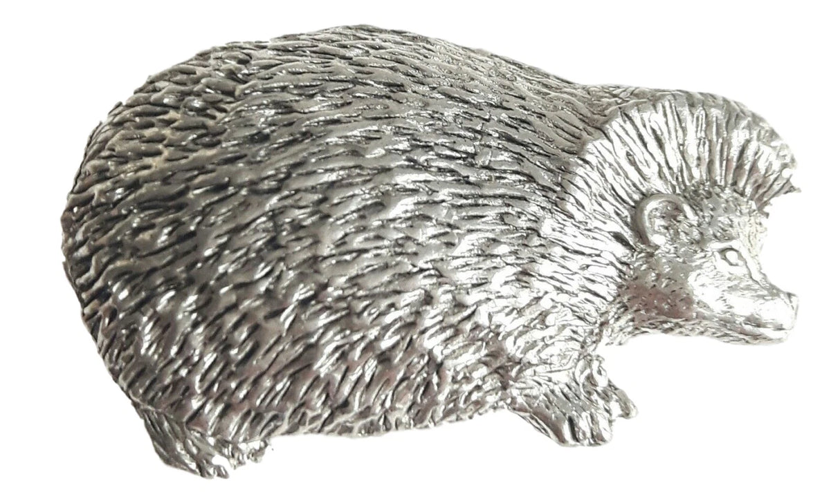 Detailed pewter hedgehog pin badge with butterfly clutch fastening on a white background.