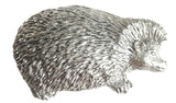 Detailed pewter hedgehog pin badge with butterfly clutch fastening on a white background.