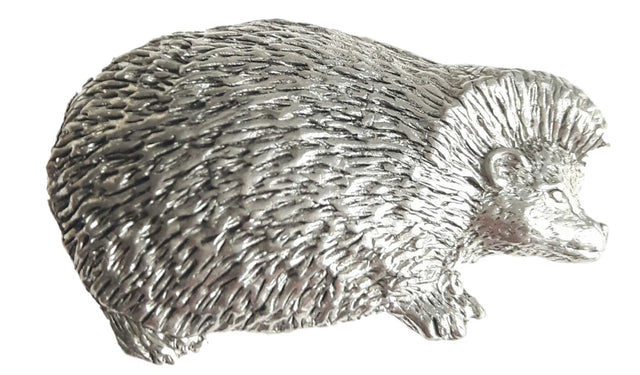 Detailed pewter hedgehog pin badge with butterfly clutch fastening on a white background.