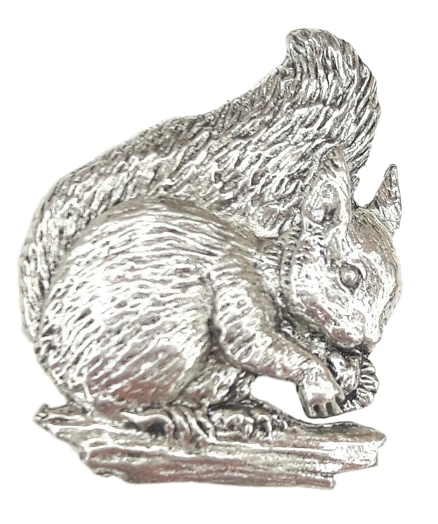 Detailed pewter squirrel pin badge holding an acorn with butterfly clutch fastening on a white background.