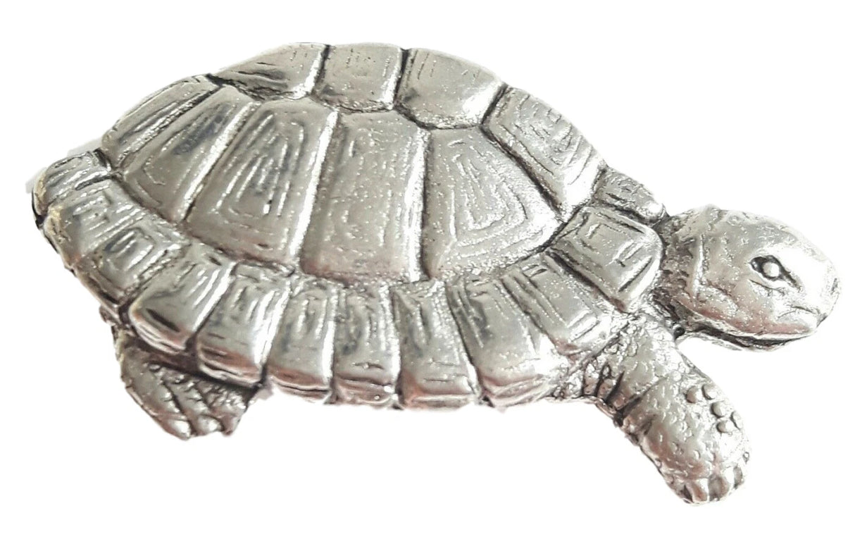 Detailed pewter tortoise pin badge with butterfly clutch fastening on a white background.