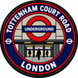 Round 80mm embroidered patch showing a stylised station entrance with an Underground roundel, people and TOTTENHAM COURT ROAD lettering, finished with a black border.