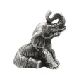English-made pewter sitting elephant figurine ornament with trunk raised and curled, first three-quarter view