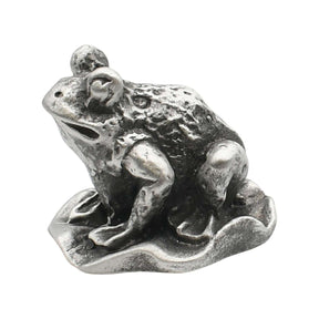 English-made pewter frog sitting on a lily pad ornament, first side view showing raised eyes and sculpted limbs