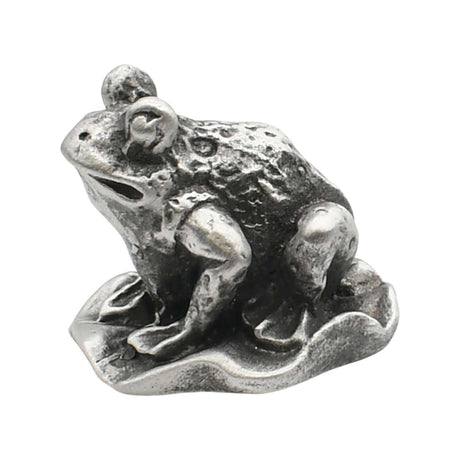 English-made pewter frog sitting on a lily pad ornament, first side view showing raised eyes and sculpted limbs