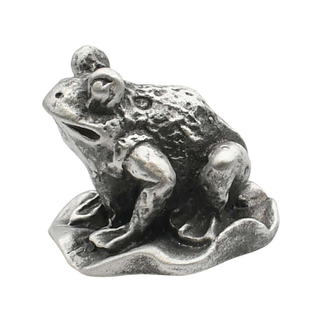 English-made pewter frog sitting on a lily pad ornament, first side view showing raised eyes and sculpted limbs