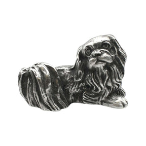 English-made pewter Pekingese dog figurine ornament lying down, with long flowing fur and a curled tail