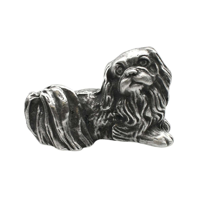 English-made pewter Pekingese dog figurine ornament lying down, with long flowing fur and a curled tail