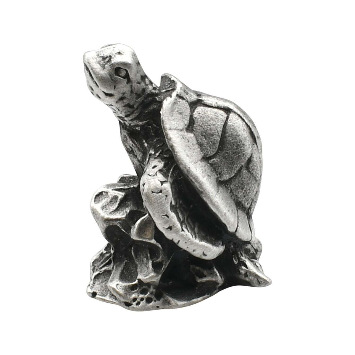 English-made pewter sea turtle on rocks figurine ornament showing raised head, textured shell and flippers on a rocky base