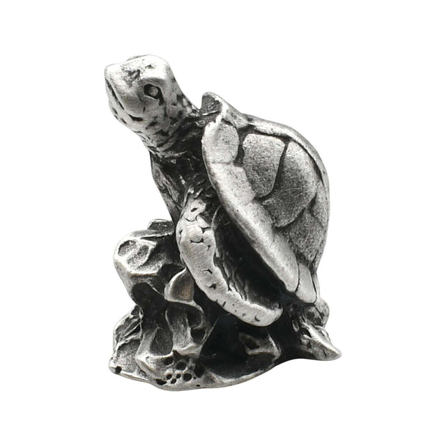 English-made pewter sea turtle on rocks figurine ornament showing raised head, textured shell and flippers on a rocky base