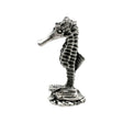 English-made pewter seahorse figurine ornament, side view showing long snout, upright ridged body and textured seabed base