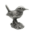 English-made pewter wren ornament perched on tree stump, first side showing raised tail and detailed wing feathers