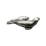 Opposite side of English-made pewter seal pup figurine featuring two seals resting together