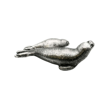 Opposite side of English-made pewter seal pup figurine featuring two seals resting together