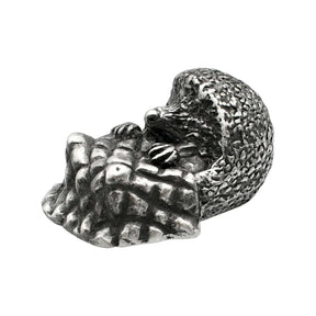 English-made pewter hedgehog with blanket ornament, curled hedgehog with textured spines and folded blanket, first angle