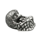 Opposite view of English-made pewter hedgehog with blanket figurine showing hedgehog face and textured spines