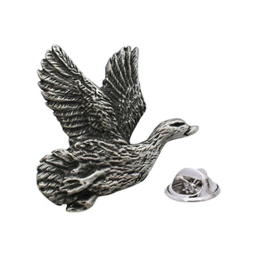 Antique silver-coloured teal duck lapel pin in flight with raised wings and butterfly fastening